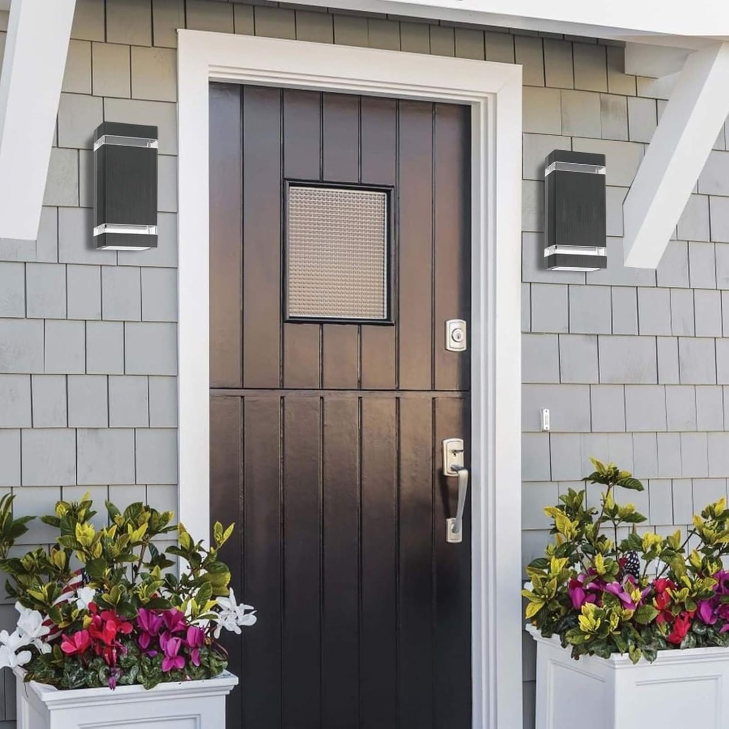 Brown door with glass panel on a gray tiled wall with flower pots.