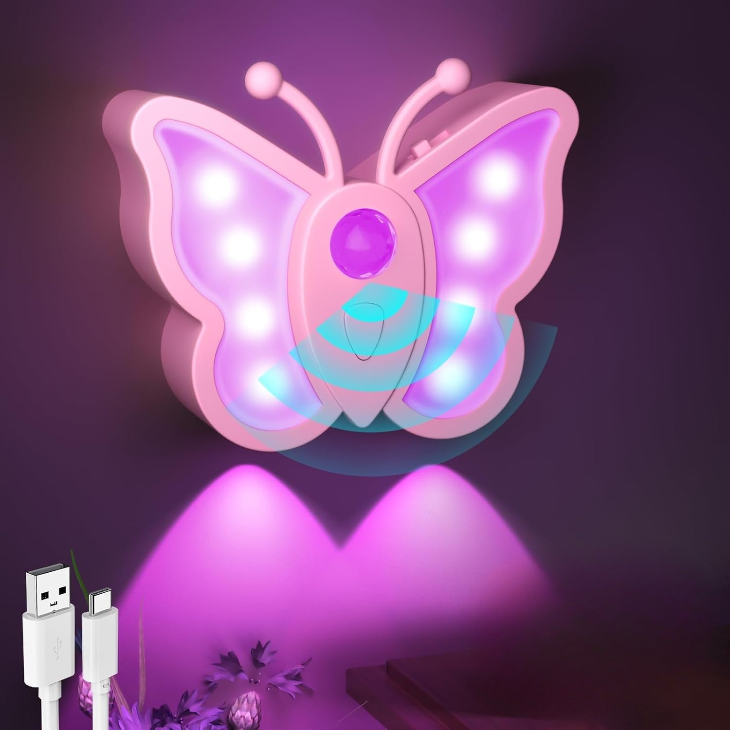 Butterfly-shaped night light with USB cable on a dark background