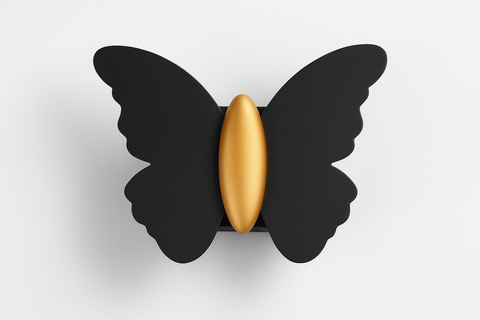 Butterfly-shaped object with a gold center on a white background