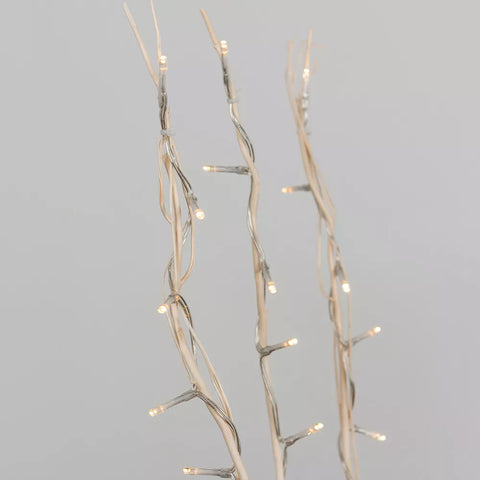 Branch fairy lights styled on side table



