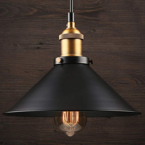 Industrial-style pendant lamp shade hanging over a modern dining table