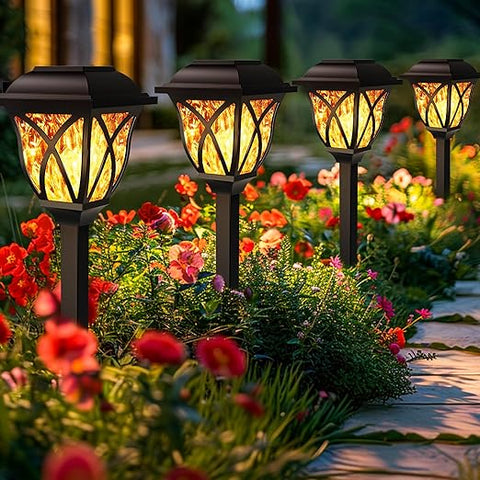 LED Solar Powered Garden Stake Light illuminating a garden pathway at night

