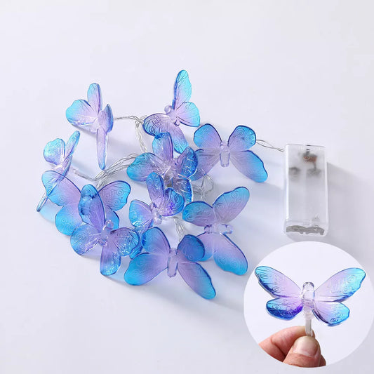 Outdoor LED butterfly fairy lights illuminating a pathway


