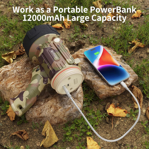 Camouflage power bank charging a smartphone outdoors on rocks with leaves.
