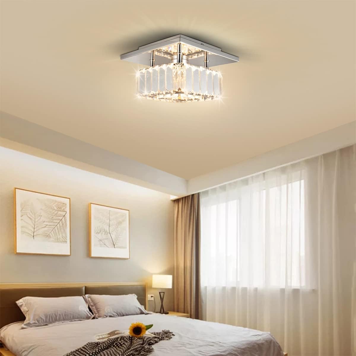 Ceiling light fixture in a bedroom setting with bed, lamp, and decor.