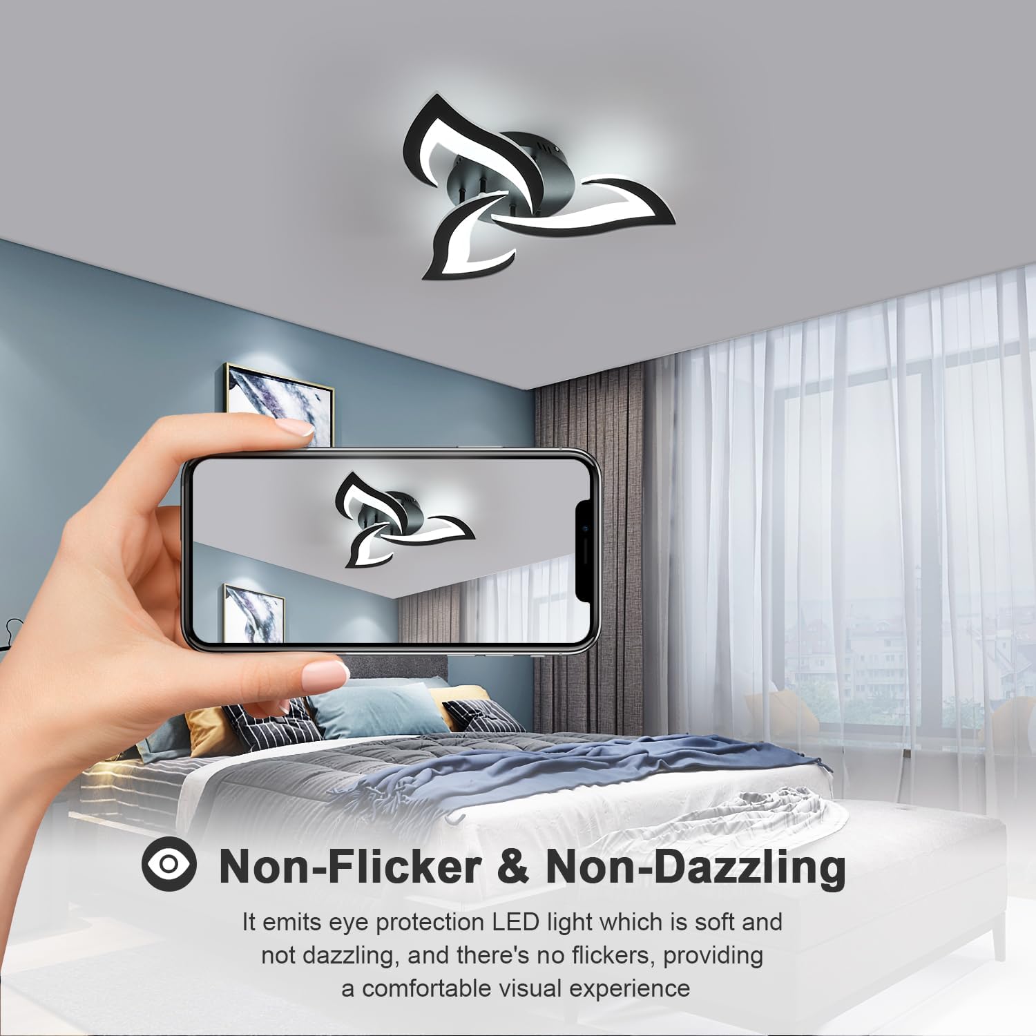 Ceiling light fixture in a bedroom with a hand holding a phone taking a photo.