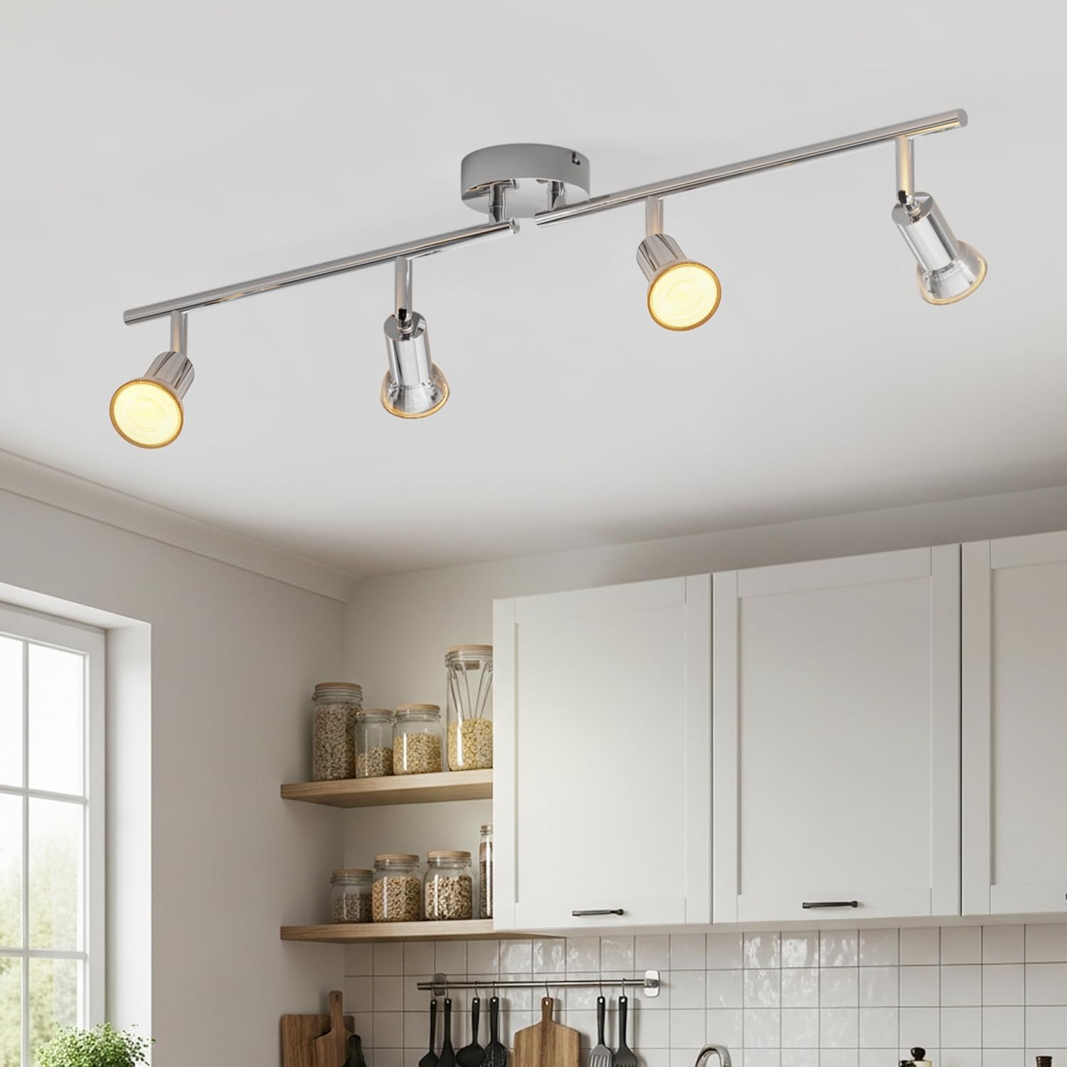Ceiling light fixture in a kitchen setting with white cabinets and window.