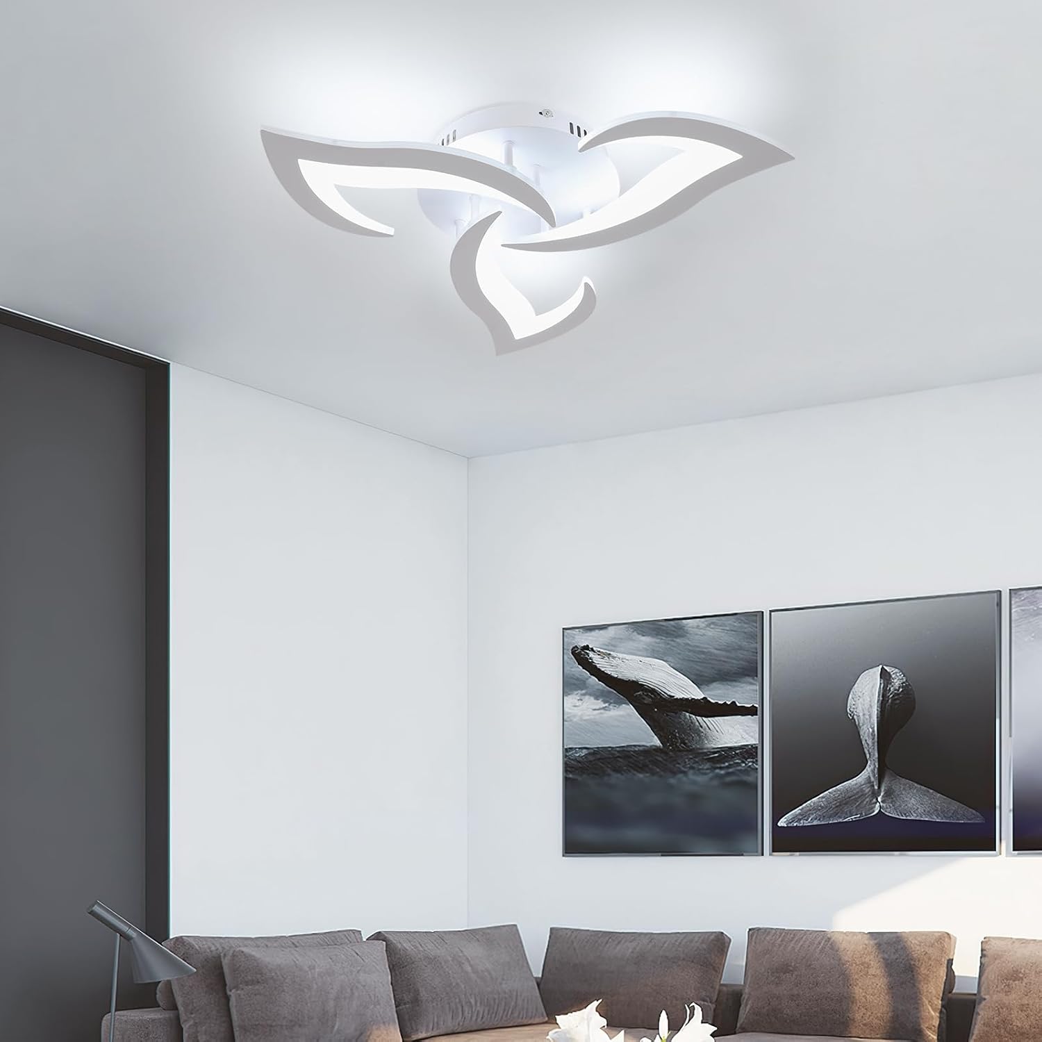 Ceiling light fixture in a modern living room with whale wall art
