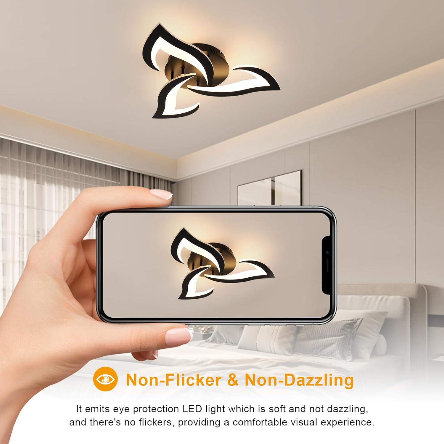 Ceiling light fixture in a room with a hand holding a phone showing the light fixture on screen.