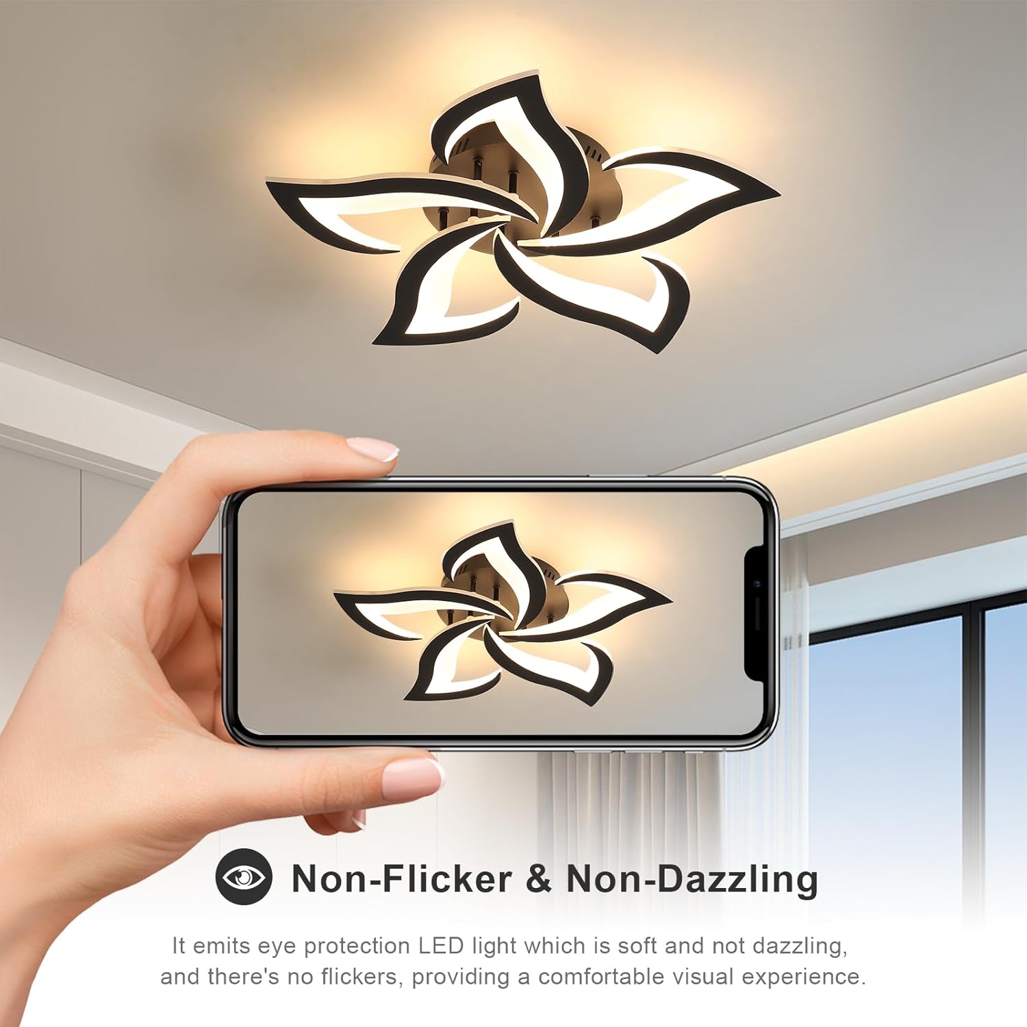 Ceiling light fixture with a hand holding a phone showing its design, in a room with a window.
