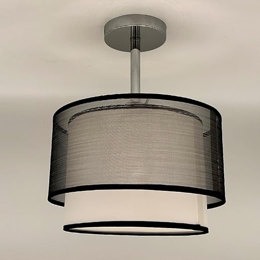 Ceiling light fixture with black and white shade on a neutral background
