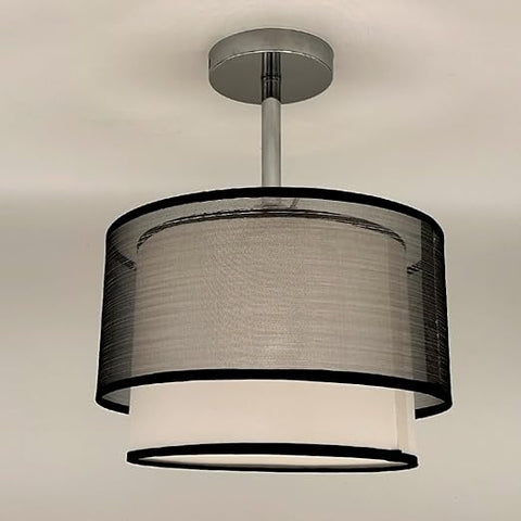 Ceiling light fixture with black and white shade on a neutral background