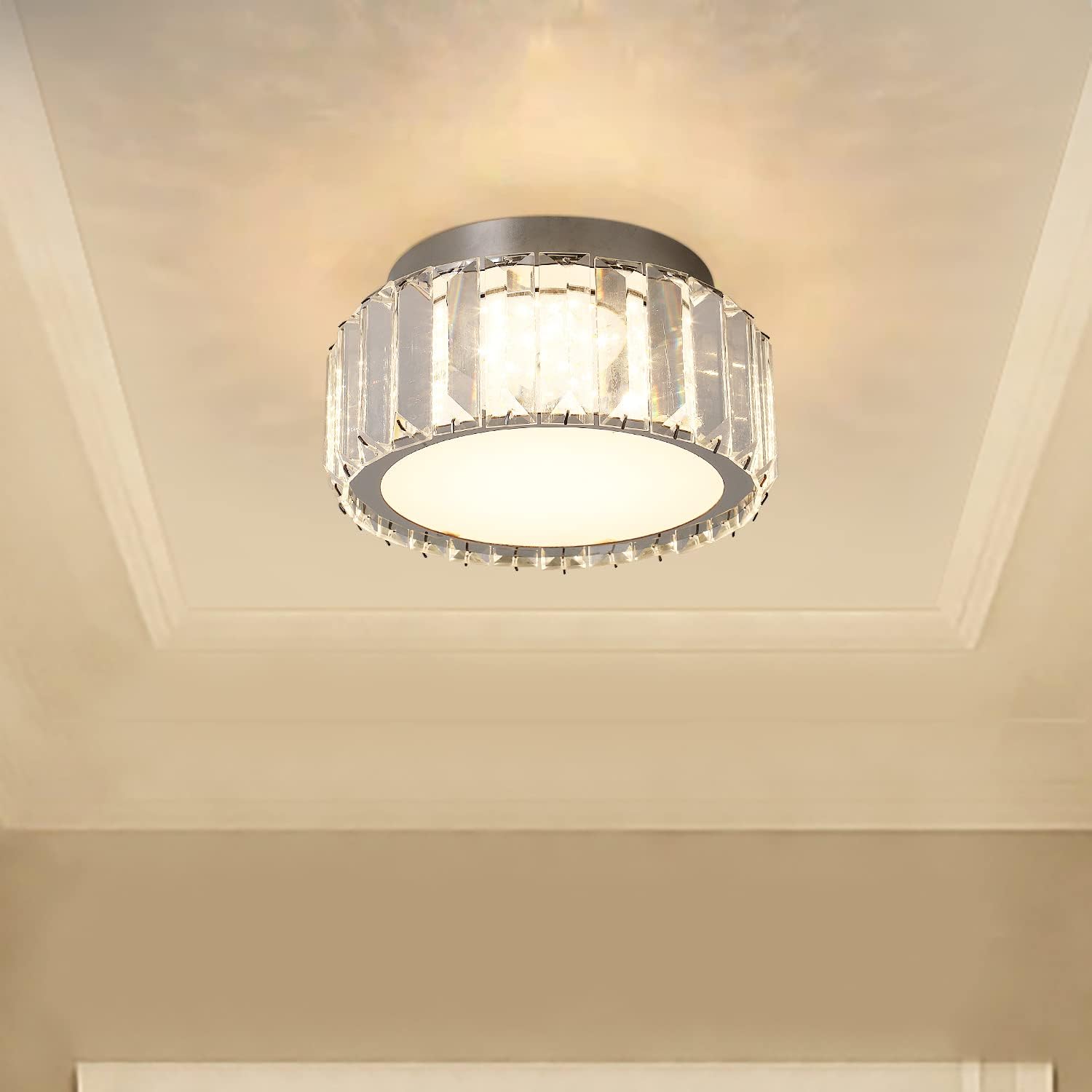 Ceiling light fixture with crystal accents on a beige ceiling