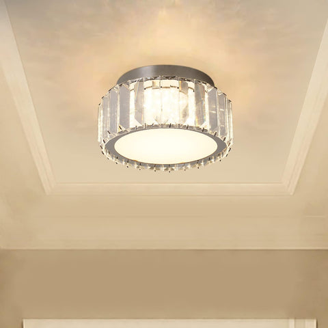 Ceiling light fixture with crystal accents on a beige ceiling
