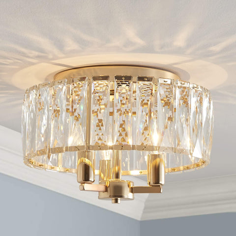 Ceiling light fixture with gold and crystal design on a ceiling