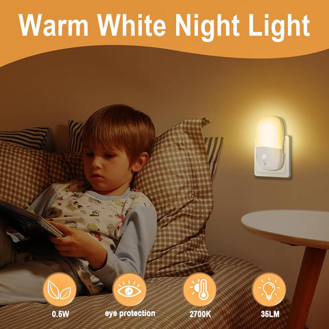 Child reading a book in bed with a warm white night light on the wall.