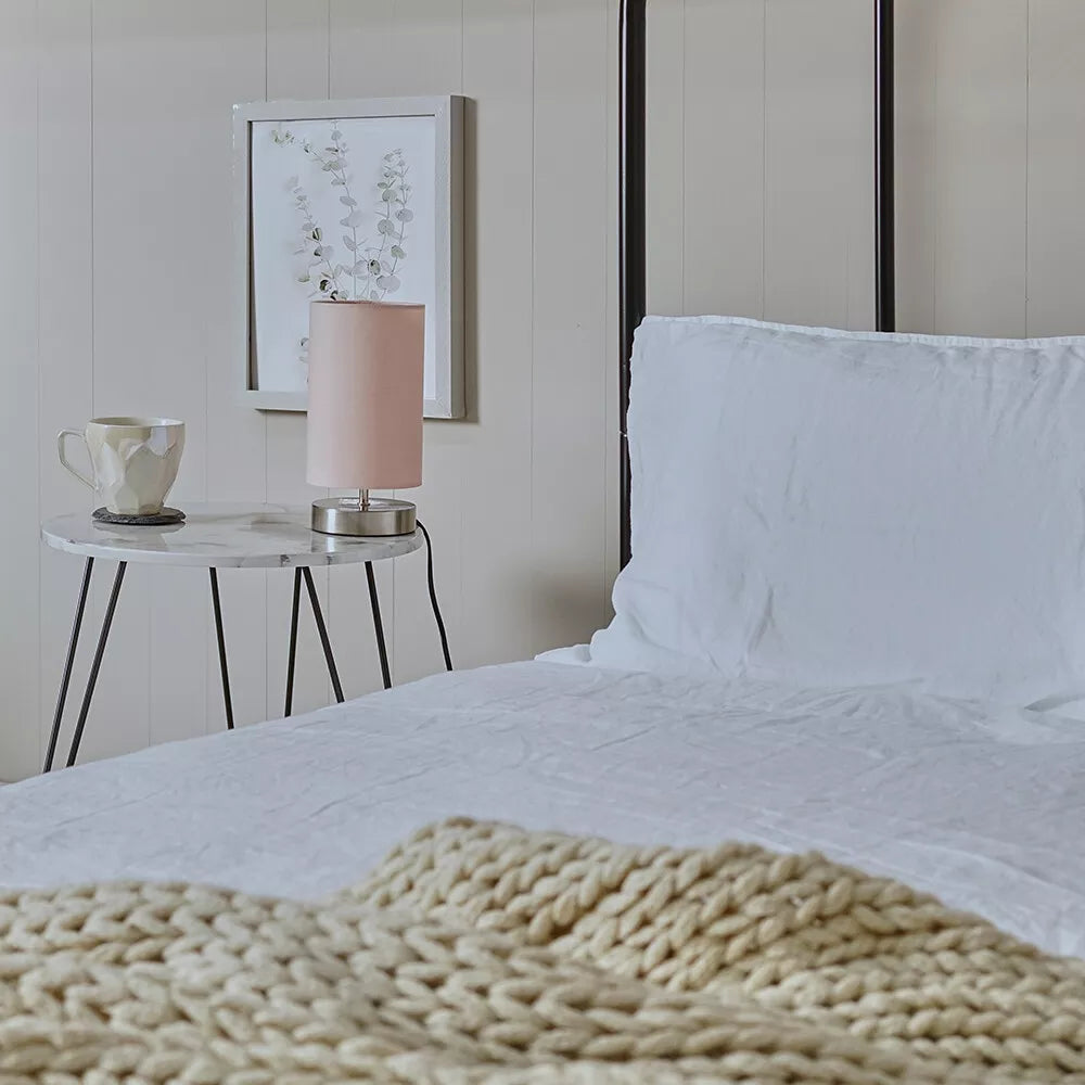 Touch-activated table lamp shown with orange lampshade on glass surface – UK.

