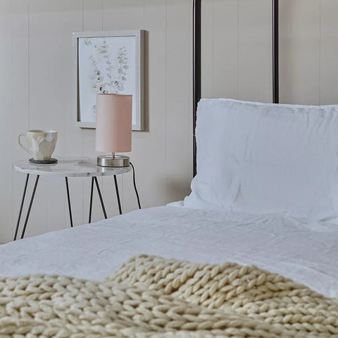 Touch-activated table lamp shown with orange lampshade on glass surface – UK.

