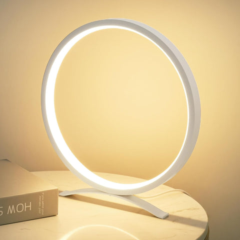 Circular LED lamp on a light surface with a soft yellow background