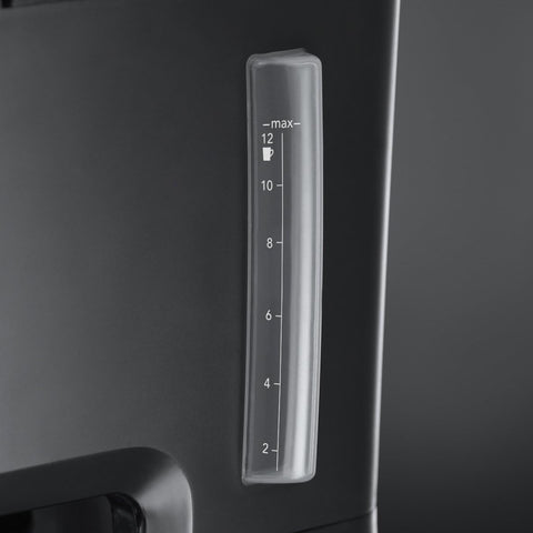 Clear measuring scale on a black appliance with a dark background