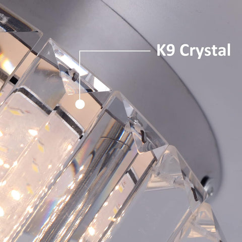 Close-up of a chandelier with K9 Crystal label on a light gray background