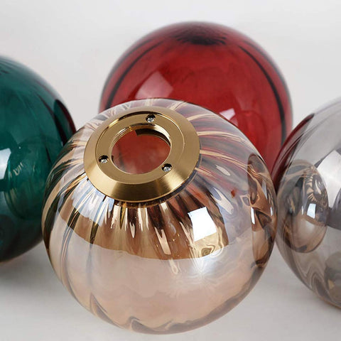 Close-up of glass lampshades with gold interior reflector on a white background