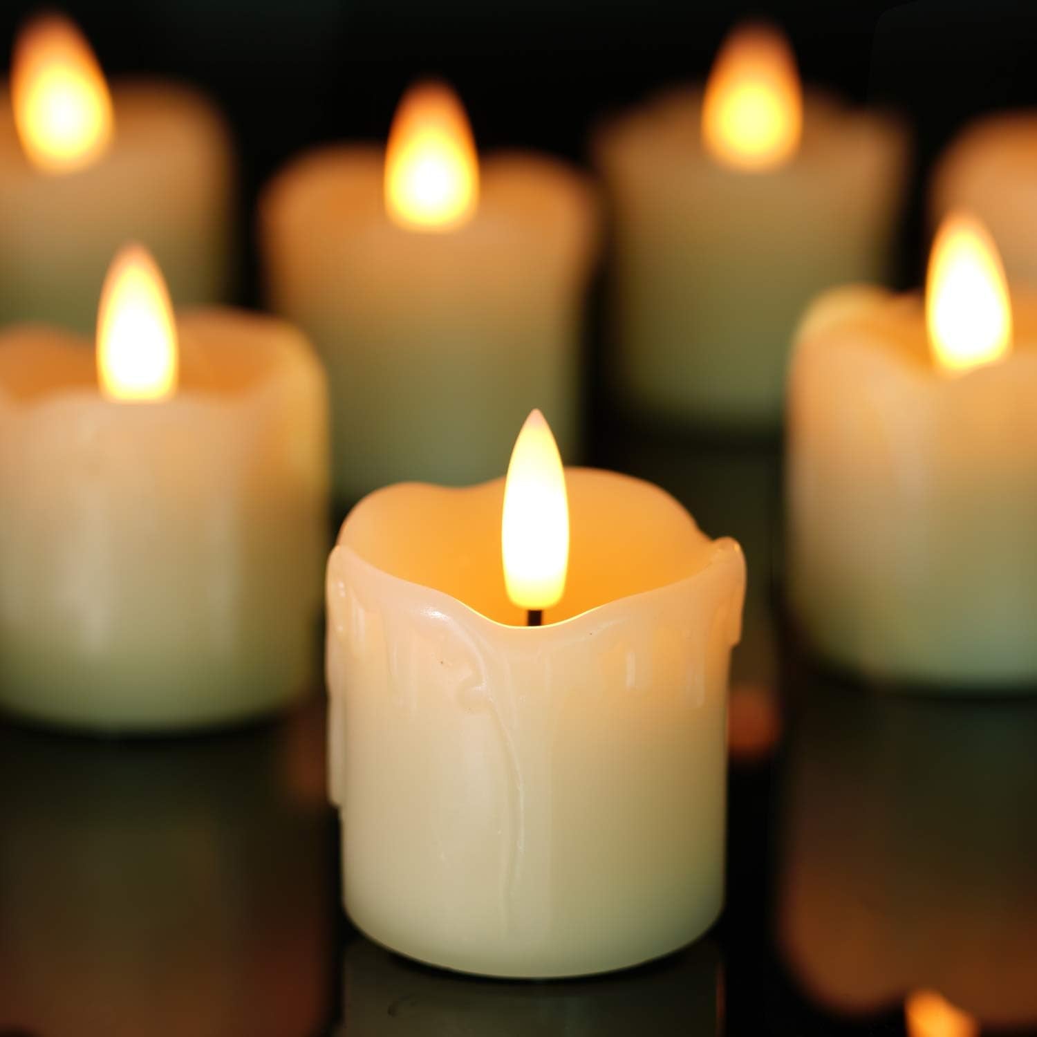 Close-up of lit candles with a dark background