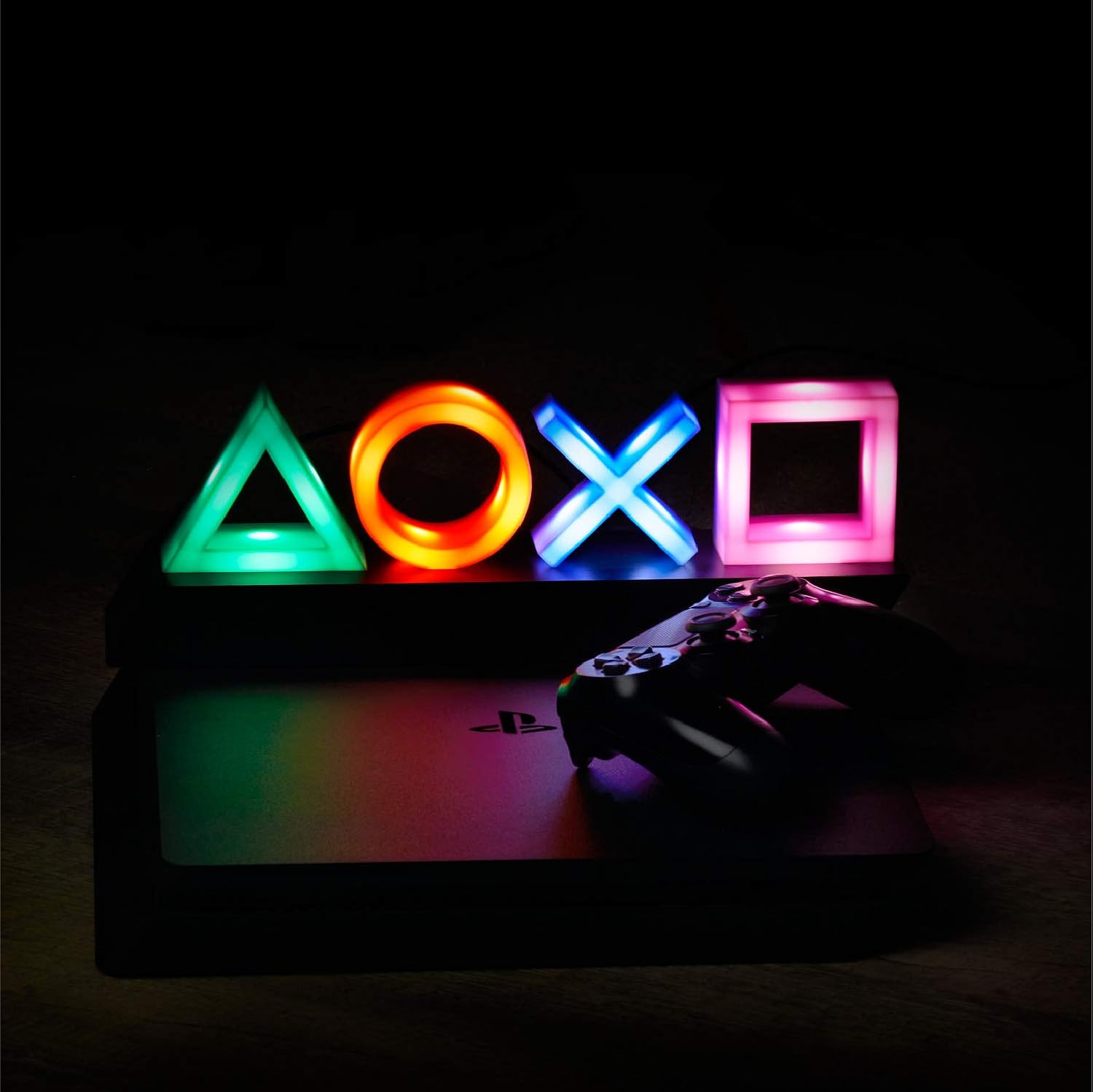 Colorful gaming controller symbols on a dark background with a gaming console and controller.