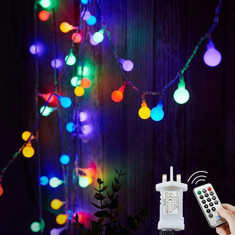 Colorful string lights with a remote control on a dark background