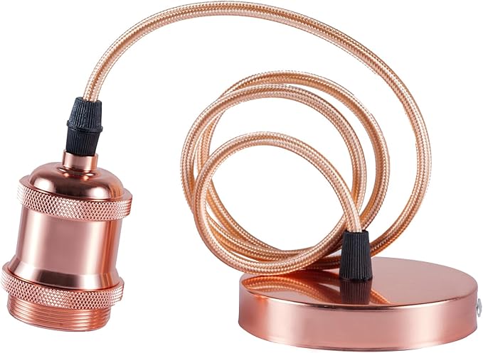 Copper lamp parts with coiled cable on a white background