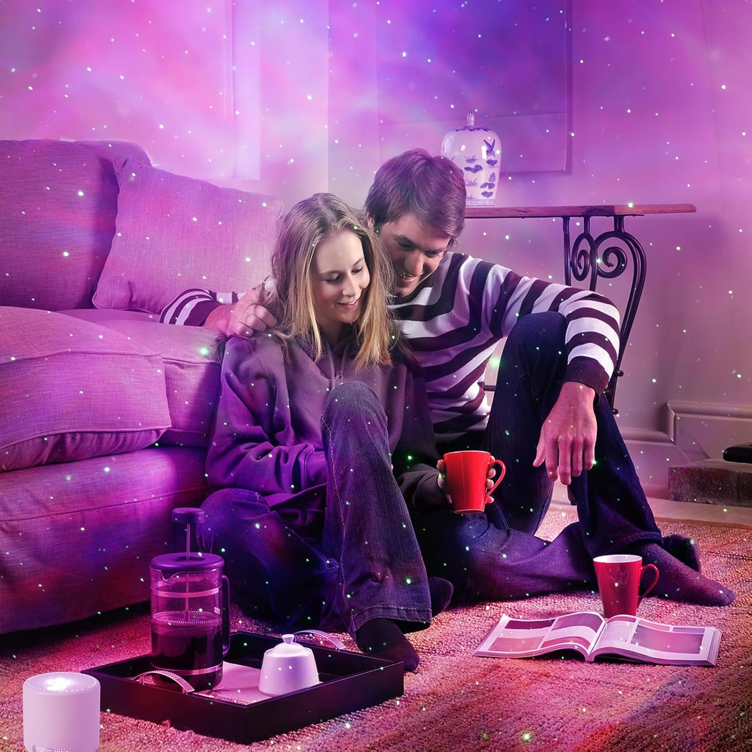 Couple sitting on a couch in a cozy room with purple lighting, holding a mug.