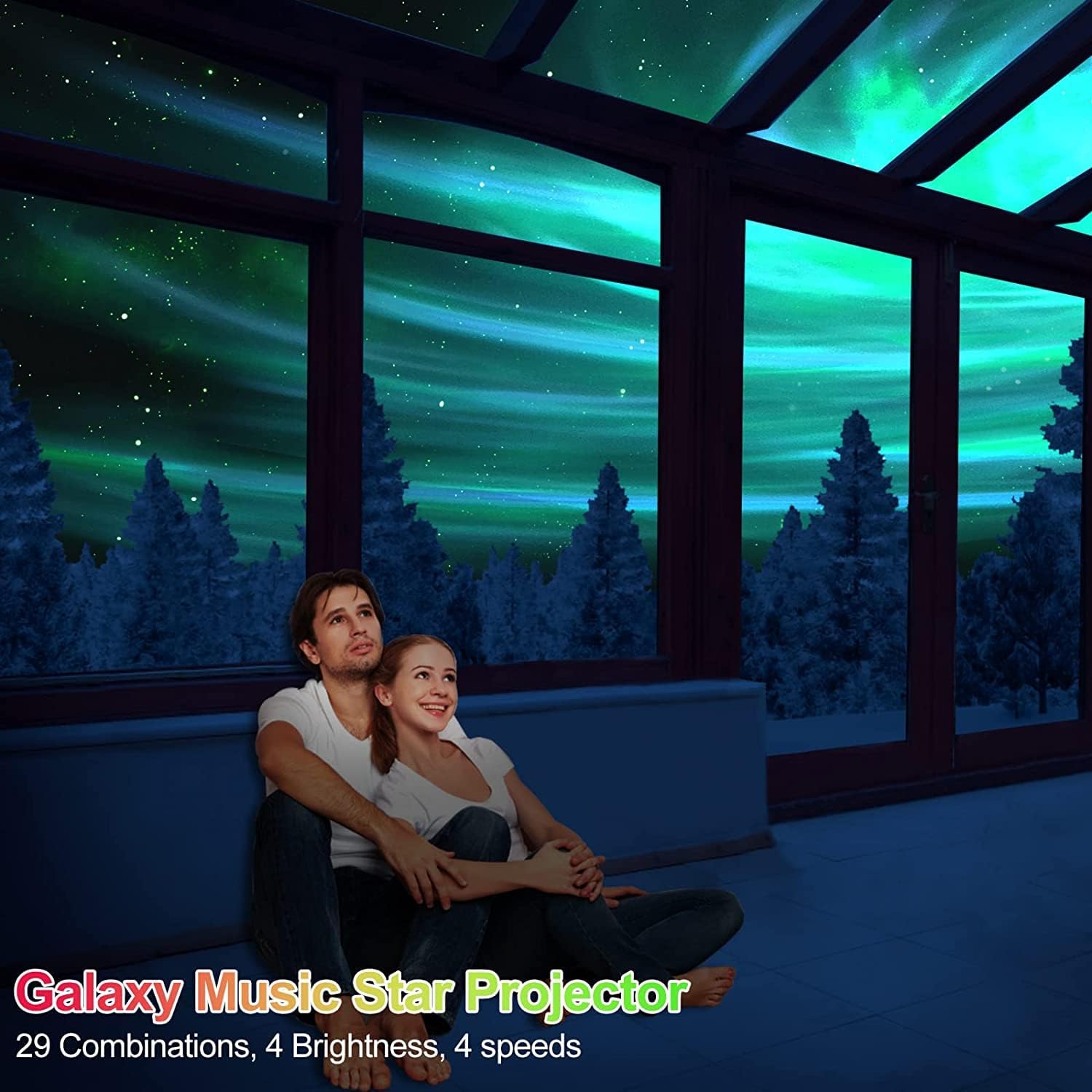 Couple sitting on a couch in a room with a galaxy-themed ceiling projection.
