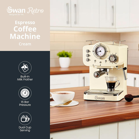 Cream-colored Swan Retro espresso coffee machine on a kitchen counter with a cup of coffee and milk frother.