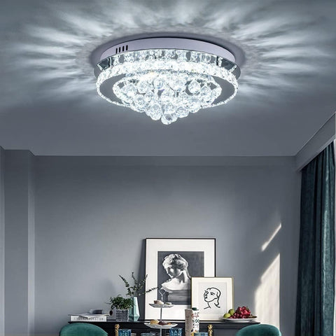 Crystal ceiling light fixture in a room with decor elements.