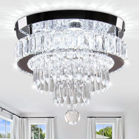 Crystal chandelier hanging from a ceiling with a room in the background