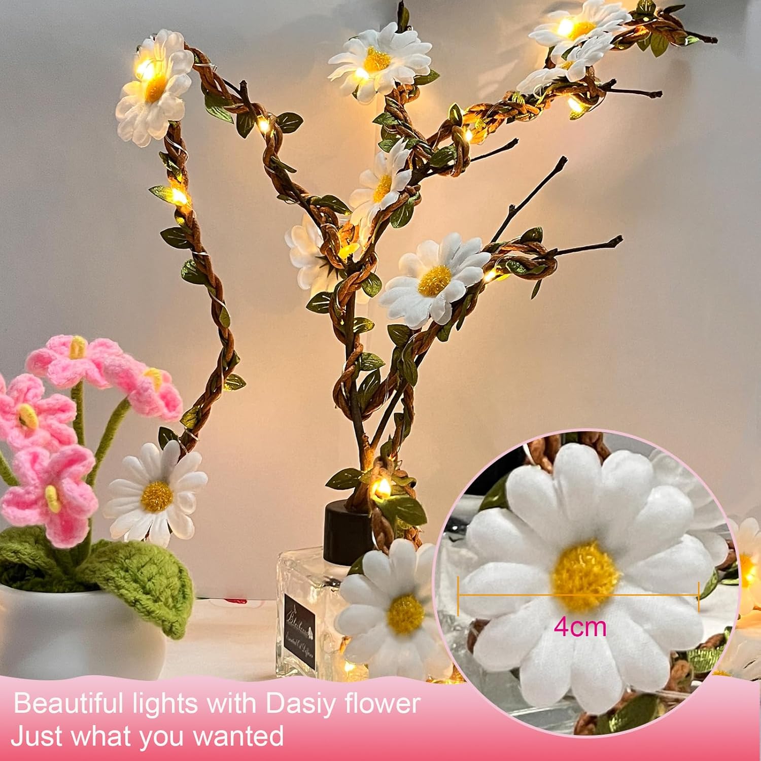 Decorative floral branch with lights and daisy flowers on a neutral background.