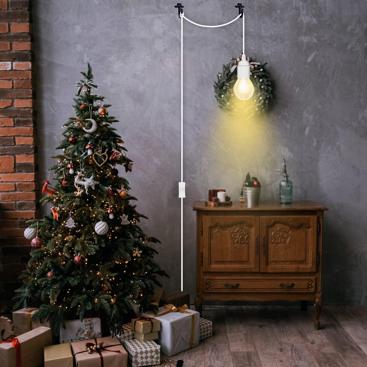Decorated Christmas tree with ornaments and lights in a room with a wooden cabinet and gift boxes.