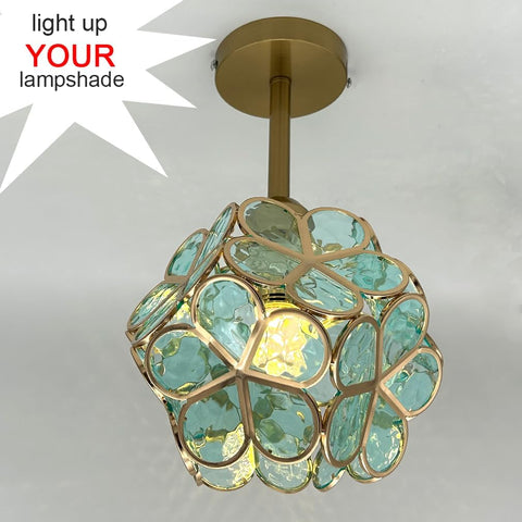 Decorative ceiling light fixture with turquoise glass and gold frame on a white background.