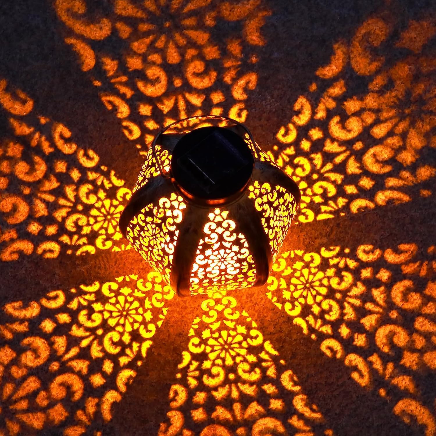 Decorative lantern casting intricate patterns on a wall