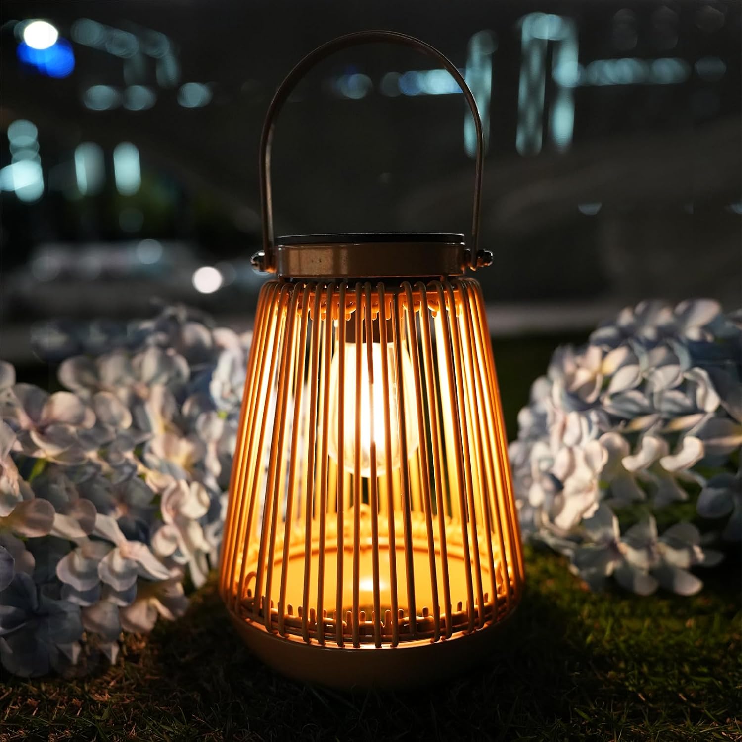 Decorative lantern with glowing light surrounded by flowers at night