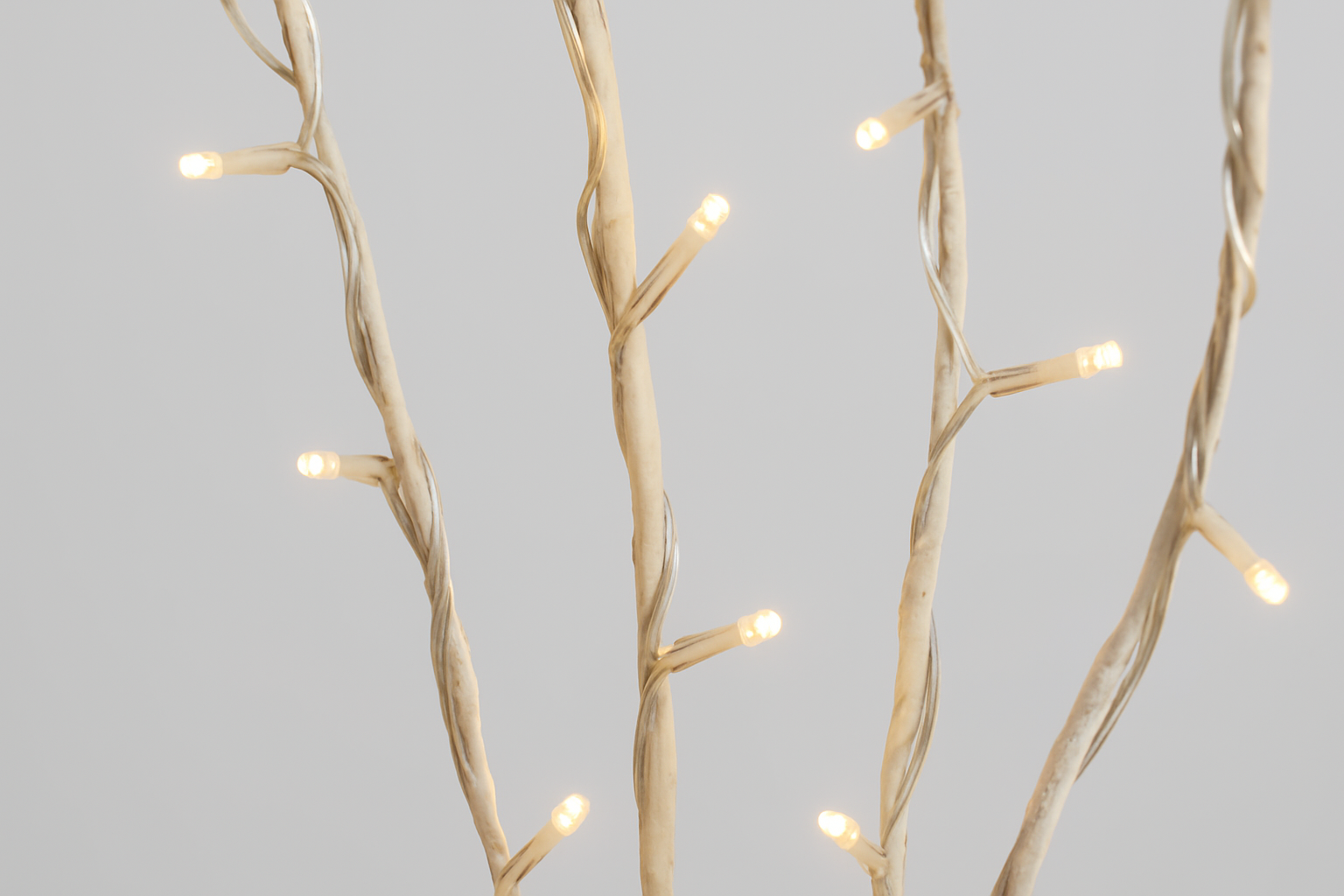 Decorative lighting fixture with branch-like design on a gray background