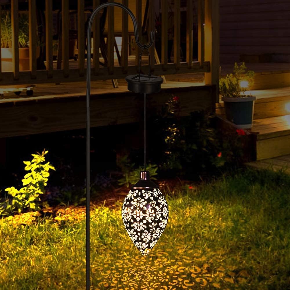 Decorative solar light on a garden path with a wooden deck in the background