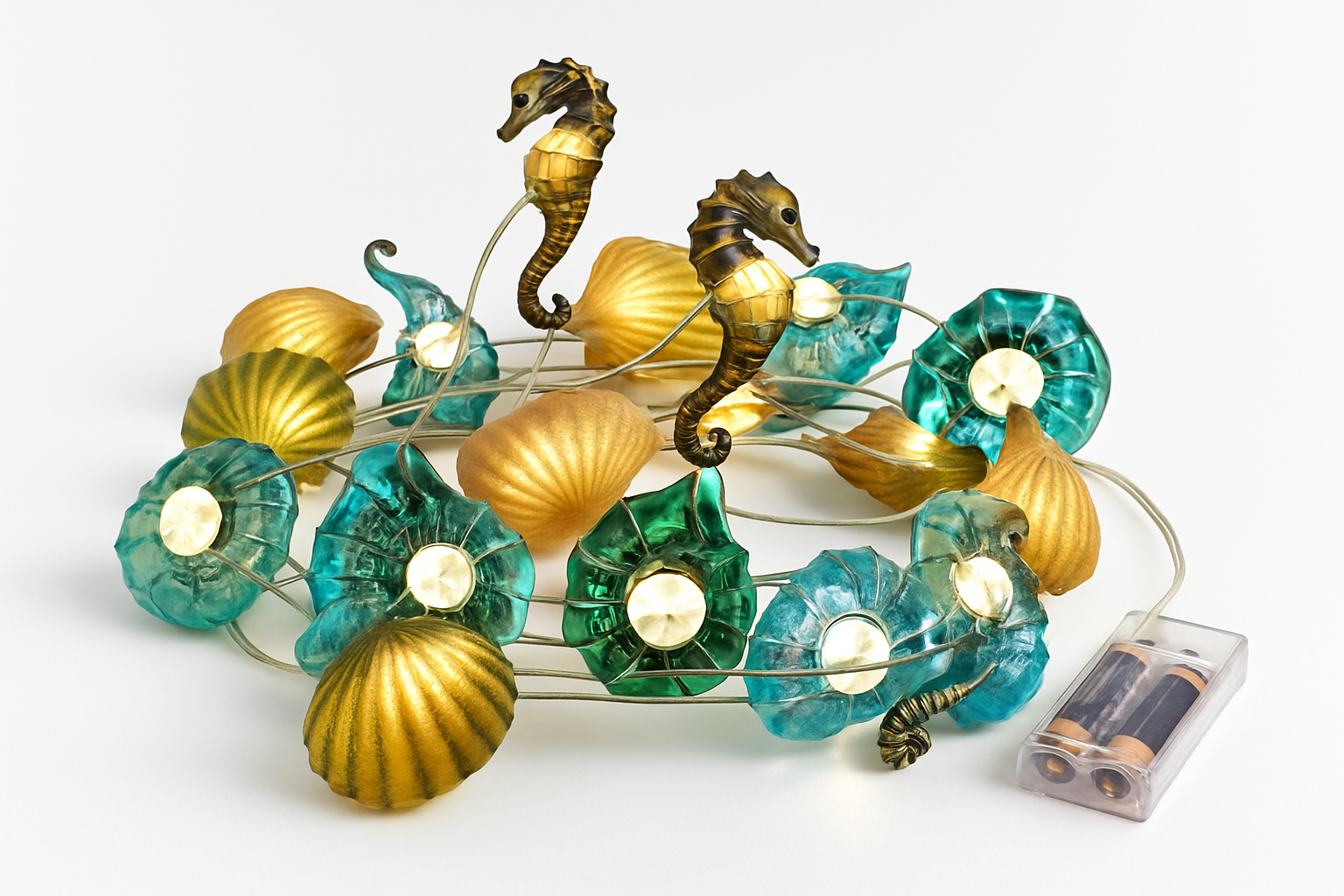 Decorative string light with seahorse and shell designs on a white background