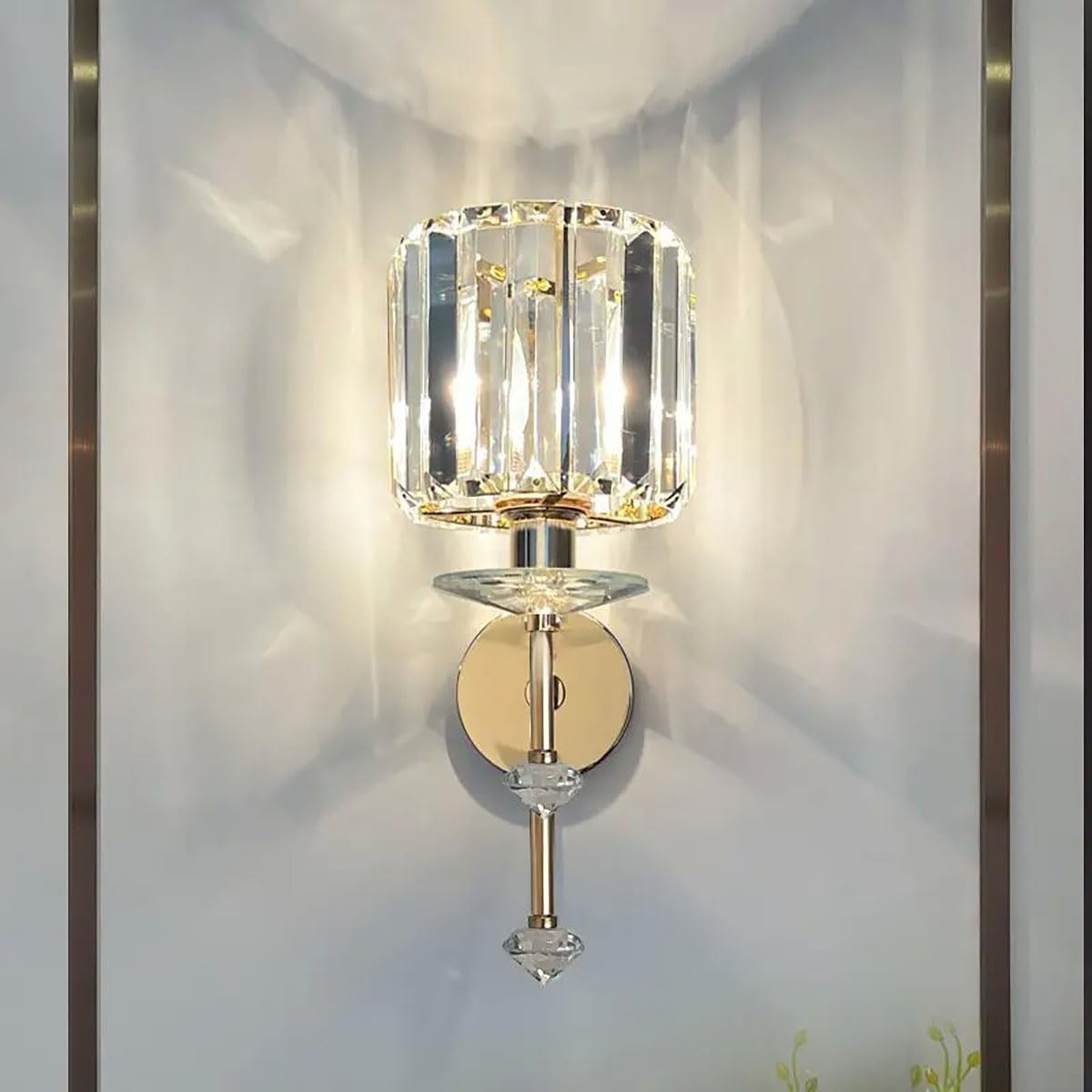 Decorative wall sconce with crystal design on a light gray wall.
