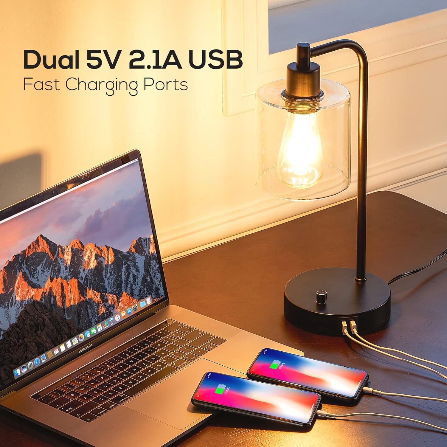 Desk setup with laptop, smartphones, and a lamp highlighting USB charging ports.