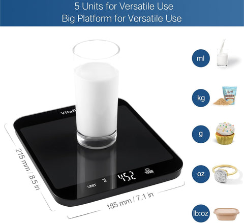 Digital kitchen scale with a glass of milk on it, displaying measurement units.
