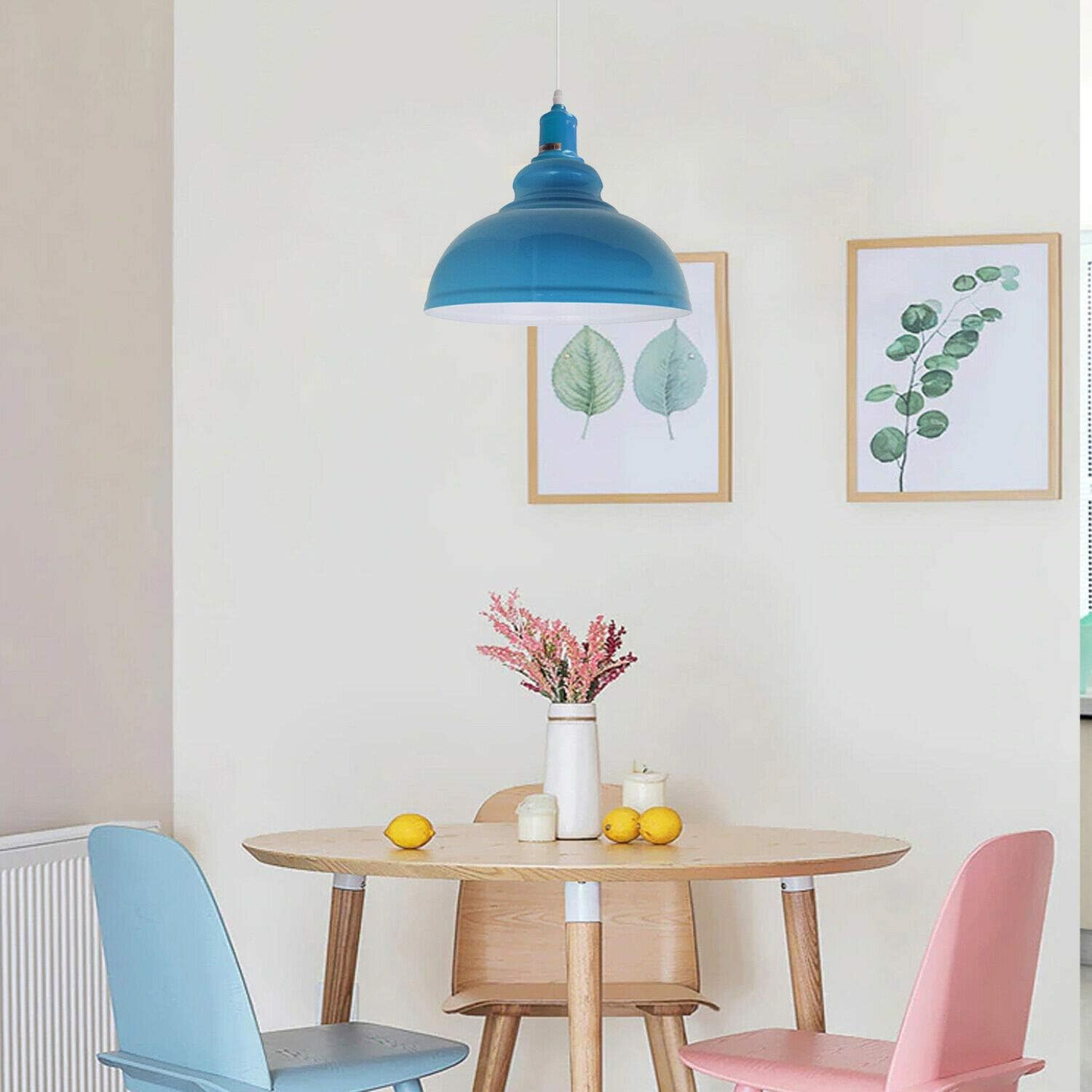 Dining area with a blue pendant light, wooden table, and colorful chairs.