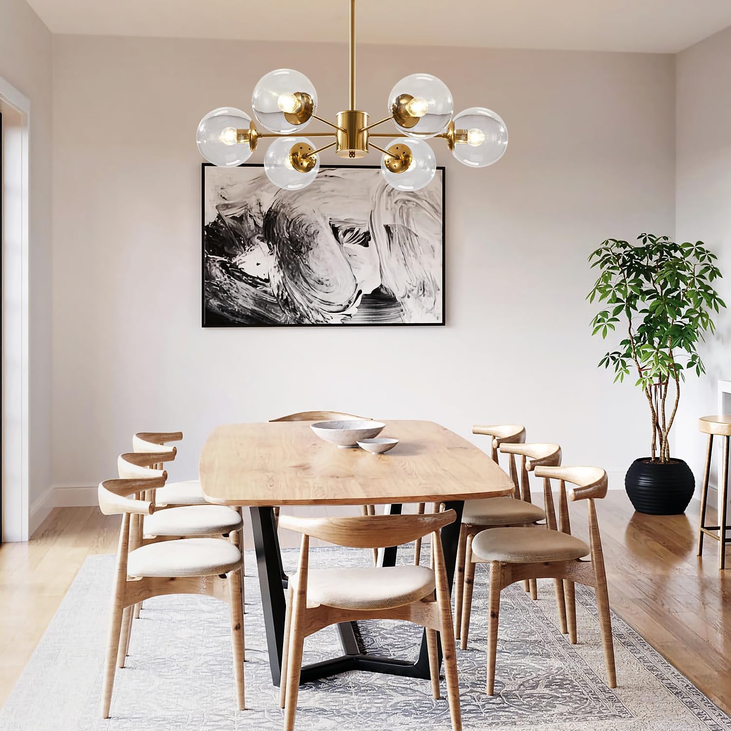 Dining room with a modern chandelier, wooden table, and chairs.