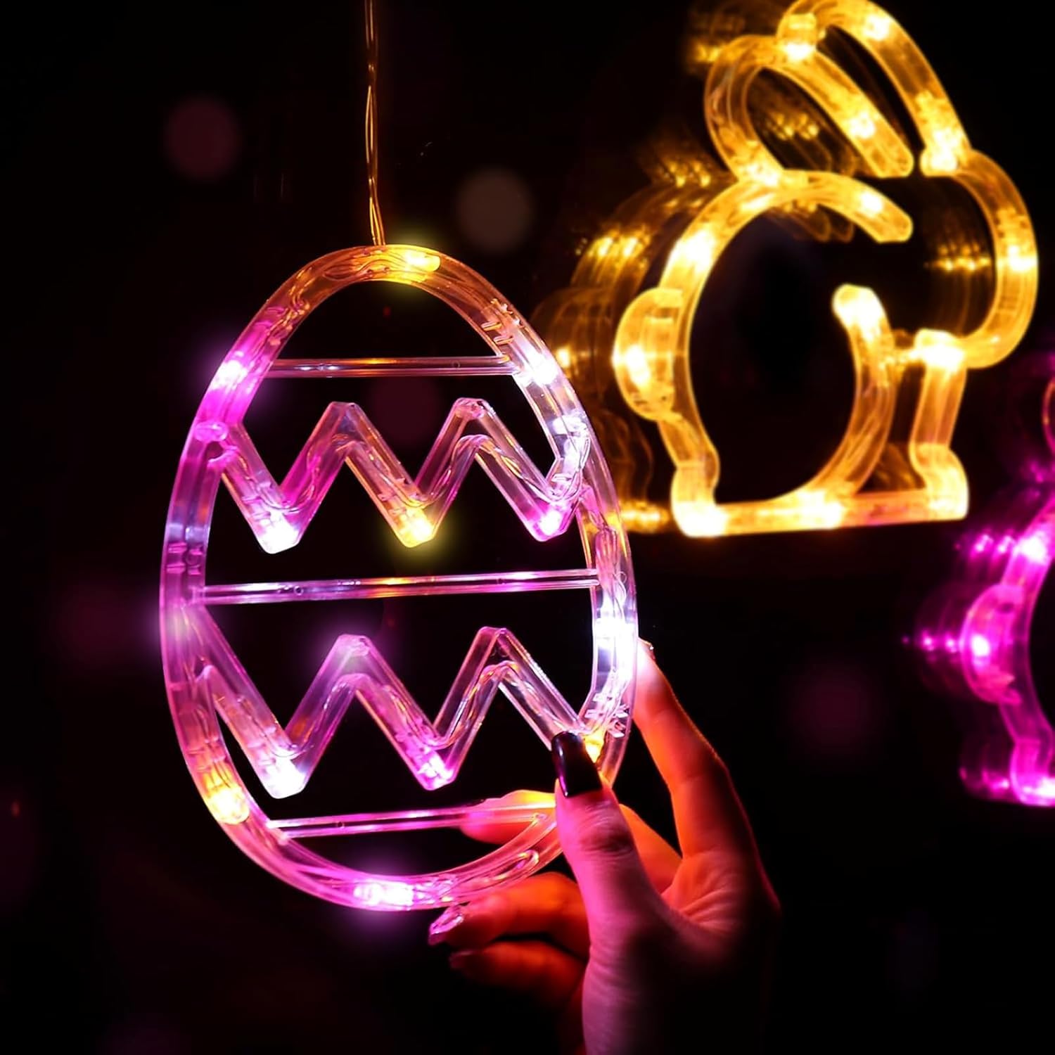 Easter bunny and egg LED lights displayed on window with suction cups