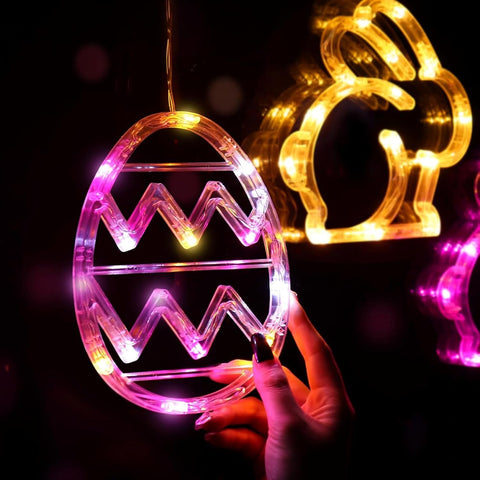 Easter bunny and egg LED lights displayed on window with suction cups